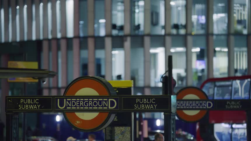 People walk through the city at night
