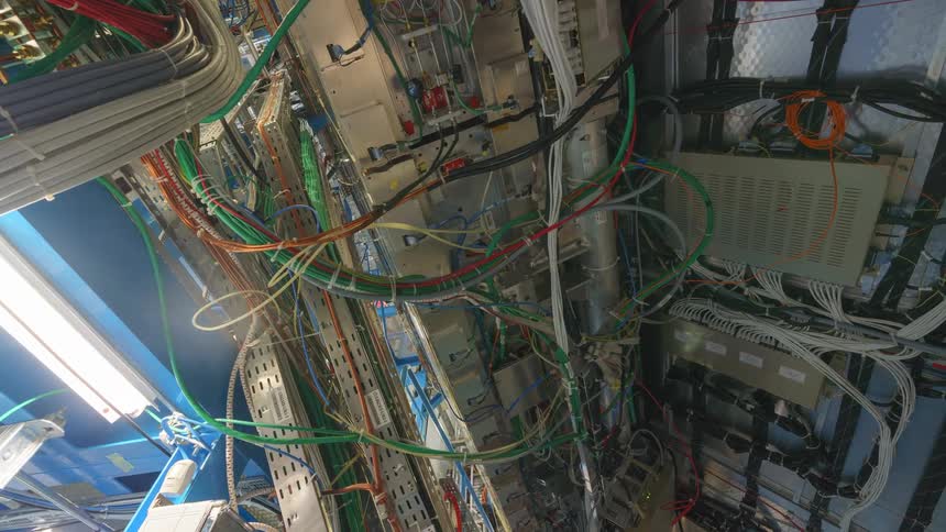 Electrical cables run up walls in industrial room with high ceiling