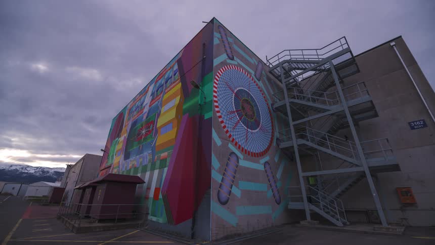 Exterior view of a graffiticovered building in timelapse as the day darkens and the sky turns purple