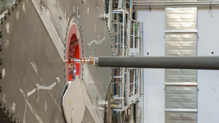 A piece of machinery is inserted into a machine