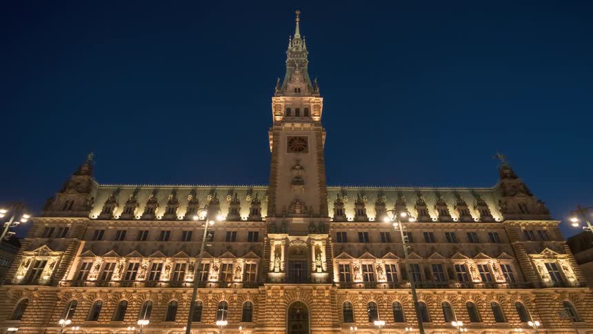 View of a building illuminated by street lamps at night