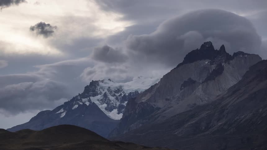 Clouds roil over a mountain range