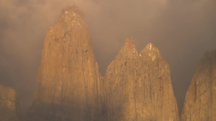 Time lapse of fog passing through mountain peaks