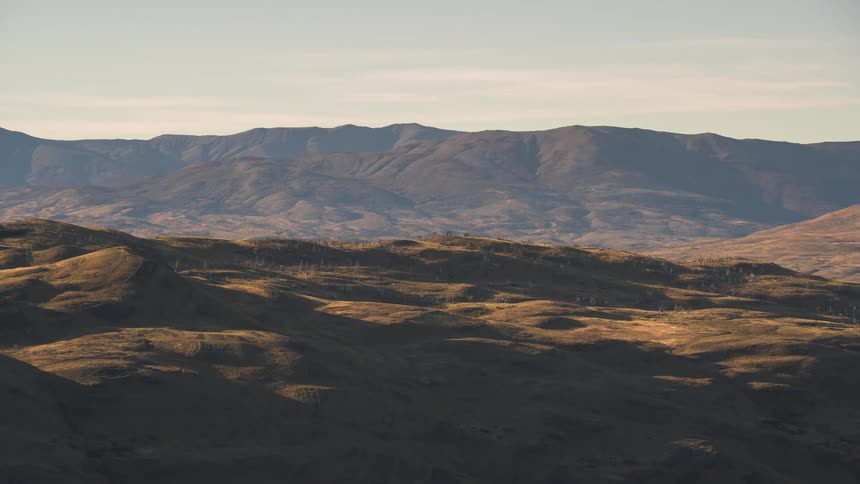 shadows moving over grasslands and mountains