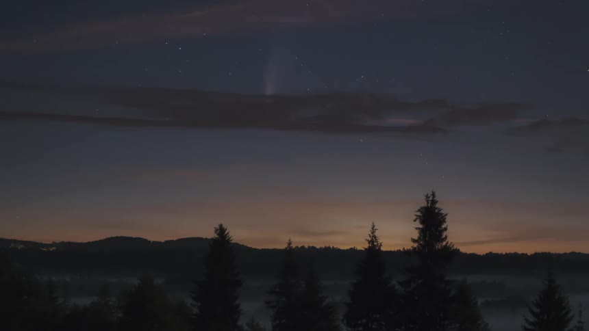 A comet moves across the night sky