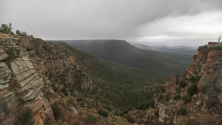 Panorama of mountain range with vegetation on a cloudy day with clouds passing by in timelapse