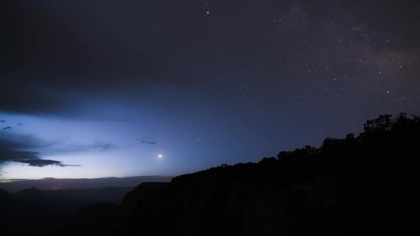 Time lapse of the day breaking with a nebulafilled sky