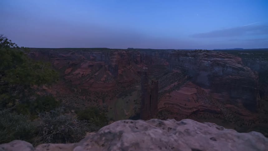 Natural panorama of a crater and canyons of the day getting dark in timelapse