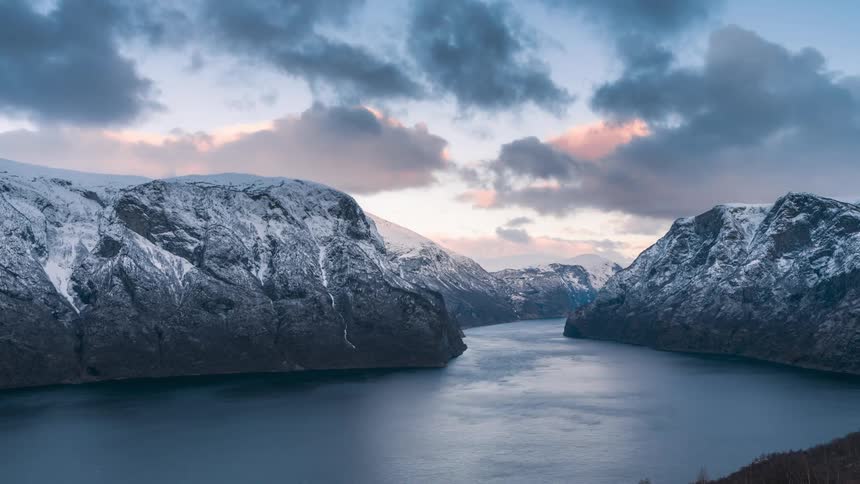 Landscape of snowy mountains near a fjord