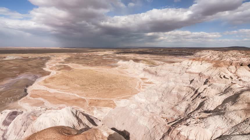 Cloud shadows move across a deep canyon