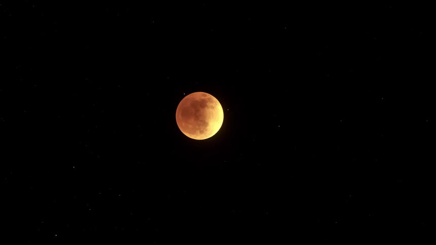 Panorama of the moon moving in timelapse at night with clouds passing by