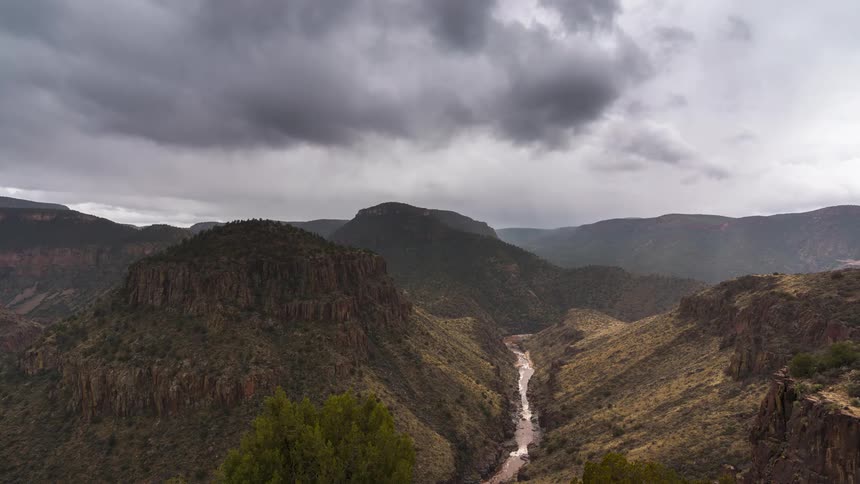 Aerial of a river in a rocky valley during a cloudy day