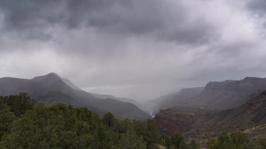 A misty and cloudy mountainous landscape under a rain storm