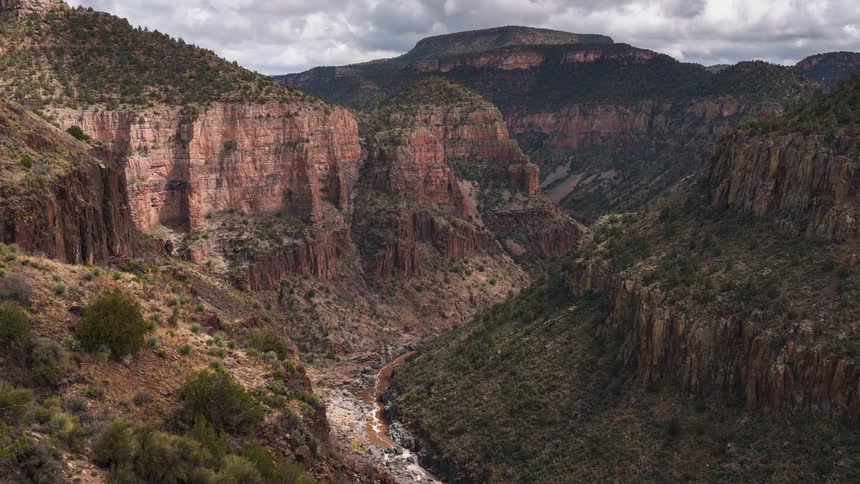 Aerial of a river in the valley with steep cliffs
