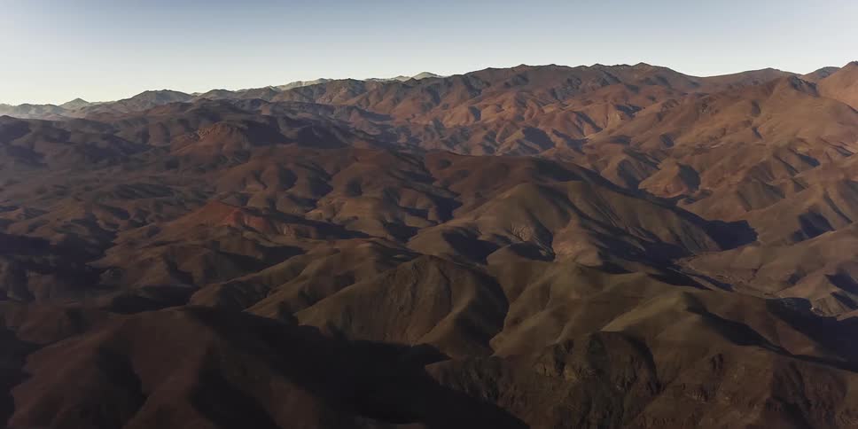 Aerial of a mountain valley during a total solar eclipse