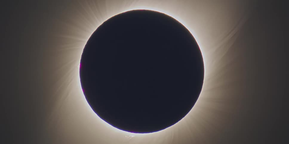 A closeup of the moon blocking the sun during a total solar eclipse