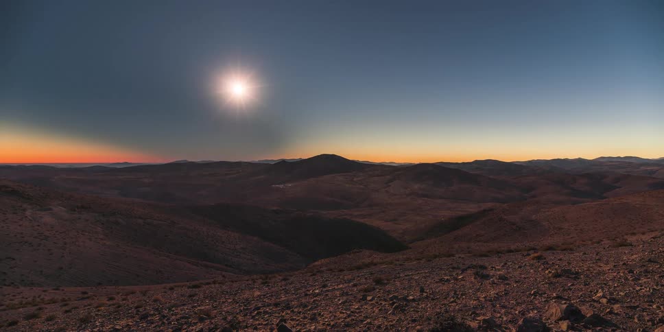 The moon casting a dark shadow on the earth during a total solar eclipse