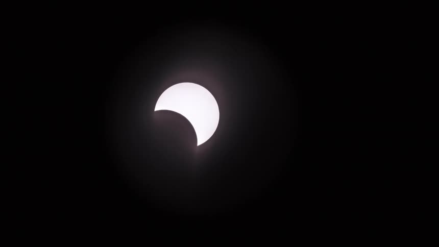 a tracking shot of the sun being eclipsed during a total solar eclipse