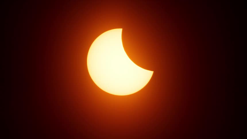 A solar eclipse is slowly taking place
