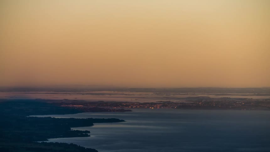 Moon set time lapse over coastal landscape