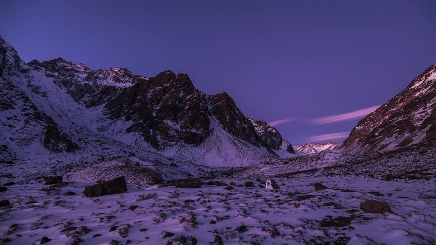 Snowcovered mountain range during sunset revealing the milkyway galaxy