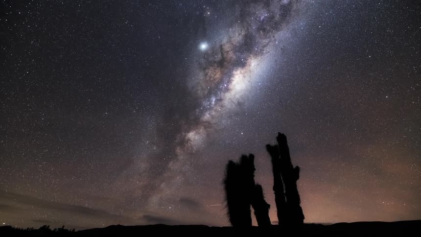 Moving milkyway galaxy with dark clouds passing by at night in timelapse