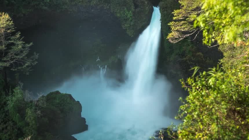 A waterfall drains into a body of water
