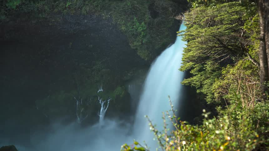 Landscape of a waterfall with free falling water in timelapse