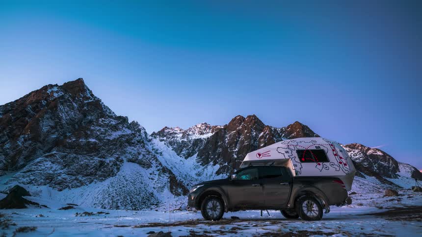 A man is camping by the mountain