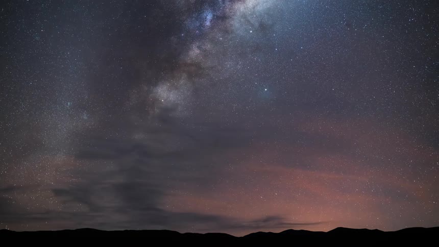 The sky is full of stars above the mountains