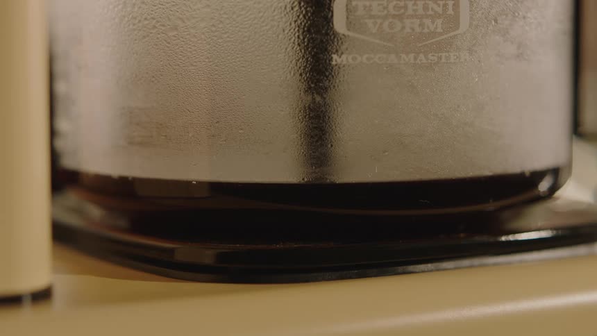 Extreme Closeup of a moccamaster coffee maker brewing coffee