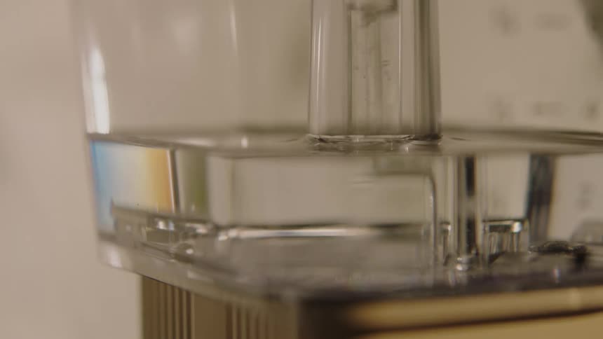Closeup of a coffee maker as the bubbles rise in the water tank
