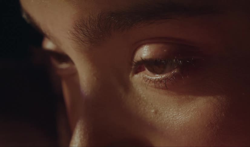 ECU of a woman's eyes blinking and looking into the sun light