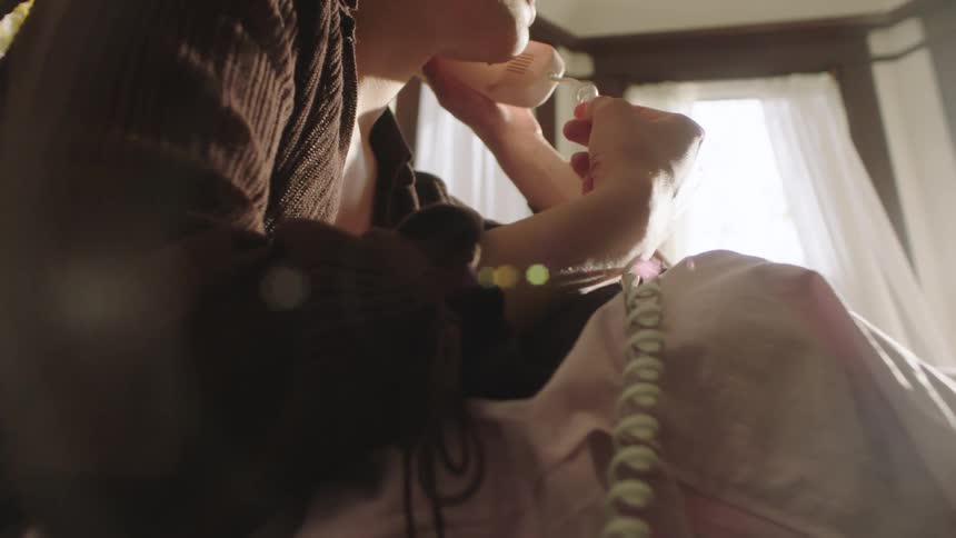 Young Woman talking on the phone and playing with the cord