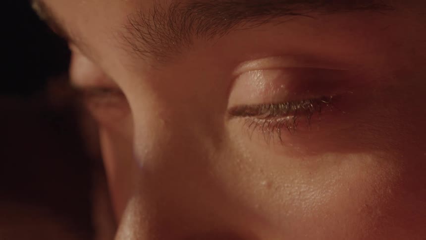 ECU of a woman's eyes blinking and looking into the sun light
