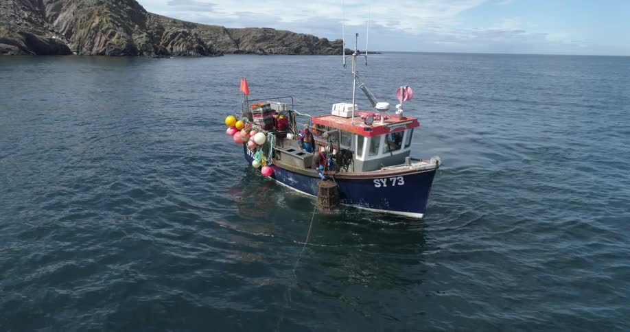 People on a fishing boat near the coast during the day