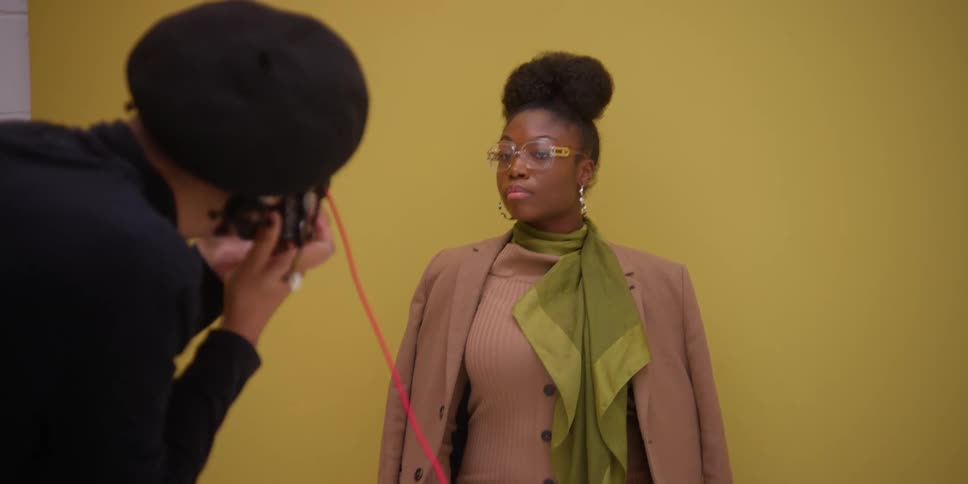 A photographer photographing a young woman for a fashion shoot