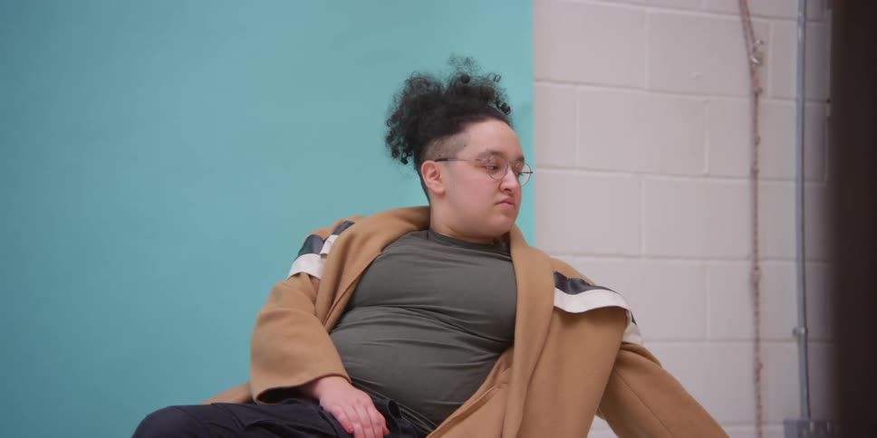 A model in a wheelchair looks around a room