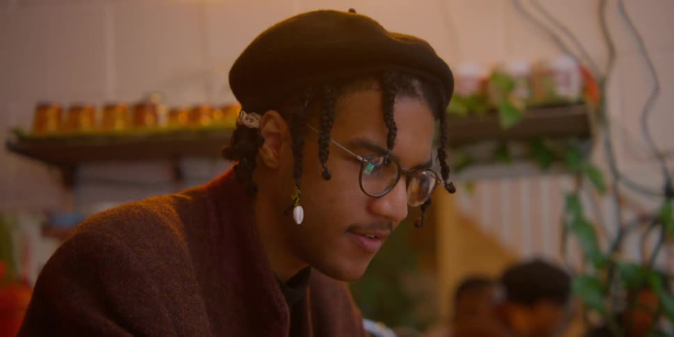 A black man types on a laptop