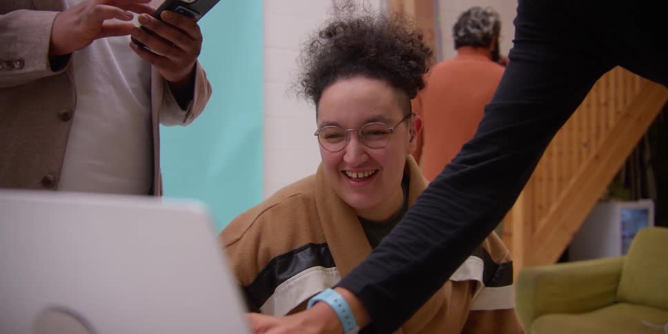 People look at a laptop together