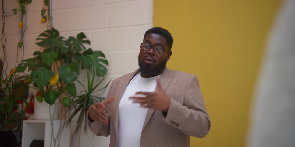 A young man giving a lecture in a clean room