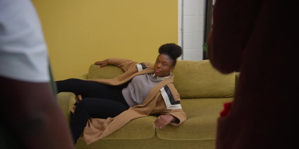 A woman sitting on the sofa posing for the camera