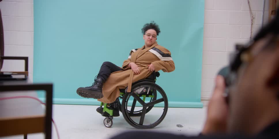 A photographer taking a portrait of a model in a wheelchair