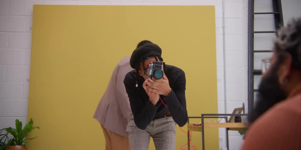 Photographer with a professional camera photographing another man