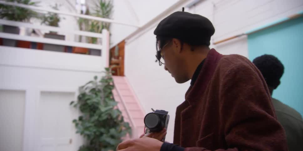Portrait of a photographer using a professional camera inside a studio