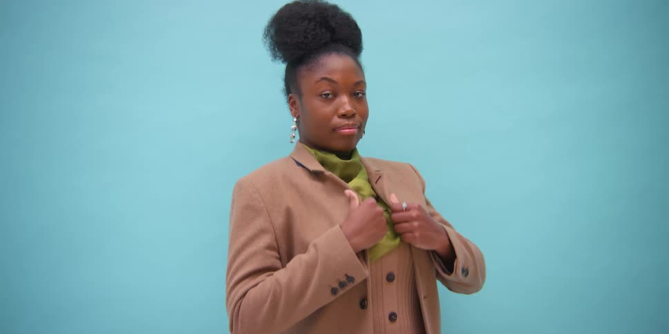A woman is posing in clothing