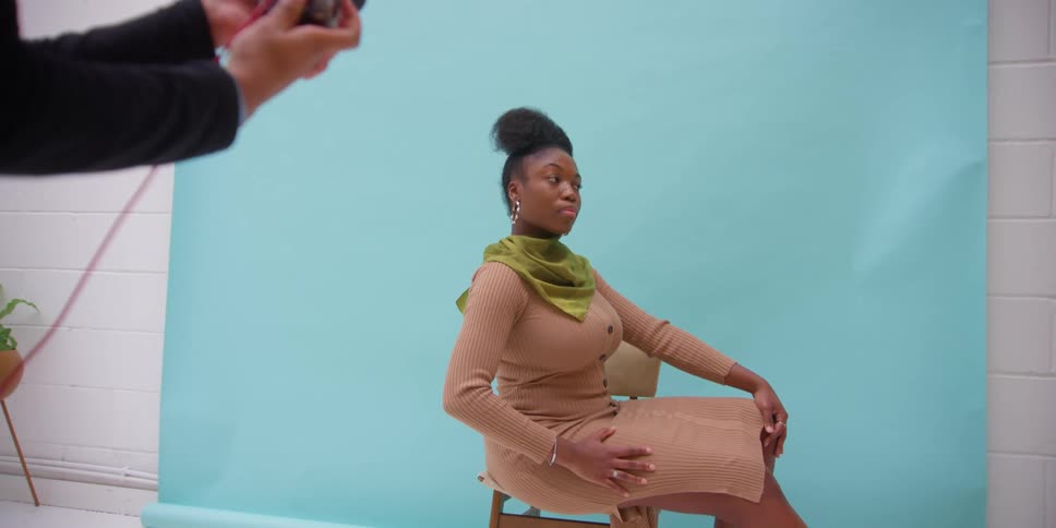 A man taking a photo of a woman in a room