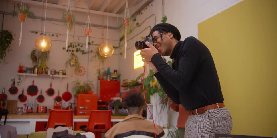 A photographer working with models in a cozy colorful studio