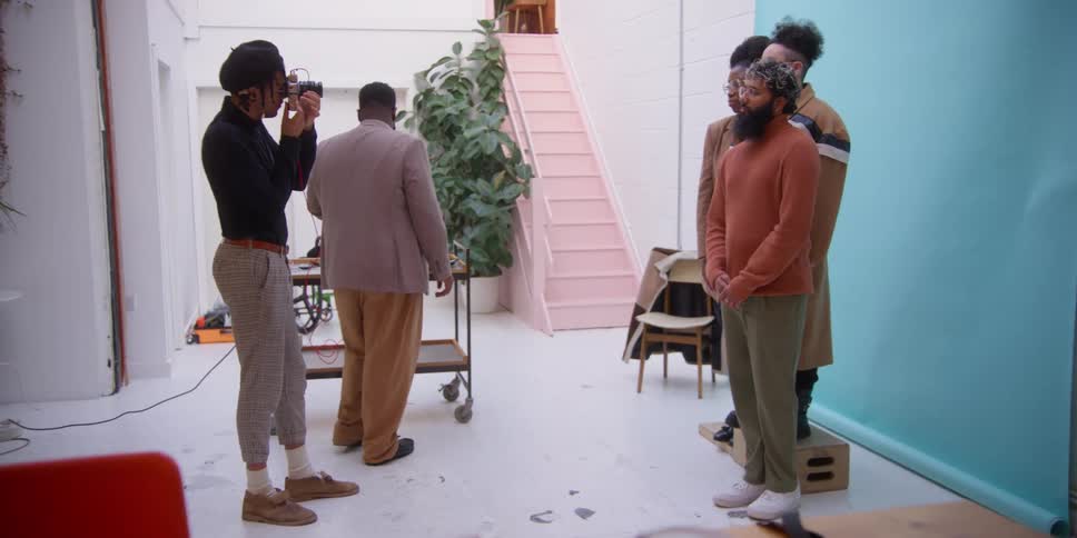 A man takes a photograph of a group of men