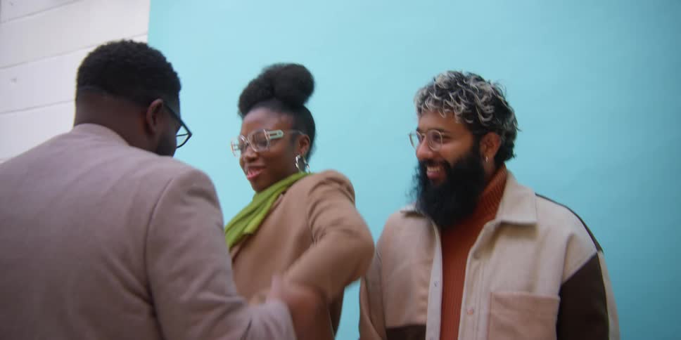 Two models start laughing when a black male positions them